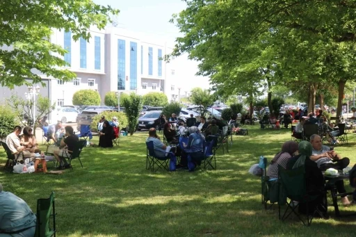 &Ccedil;ocuklar i&ccedil;eride ter d&ouml;kt&uuml;, aileler dışarıda piknik yaparak bekledi
